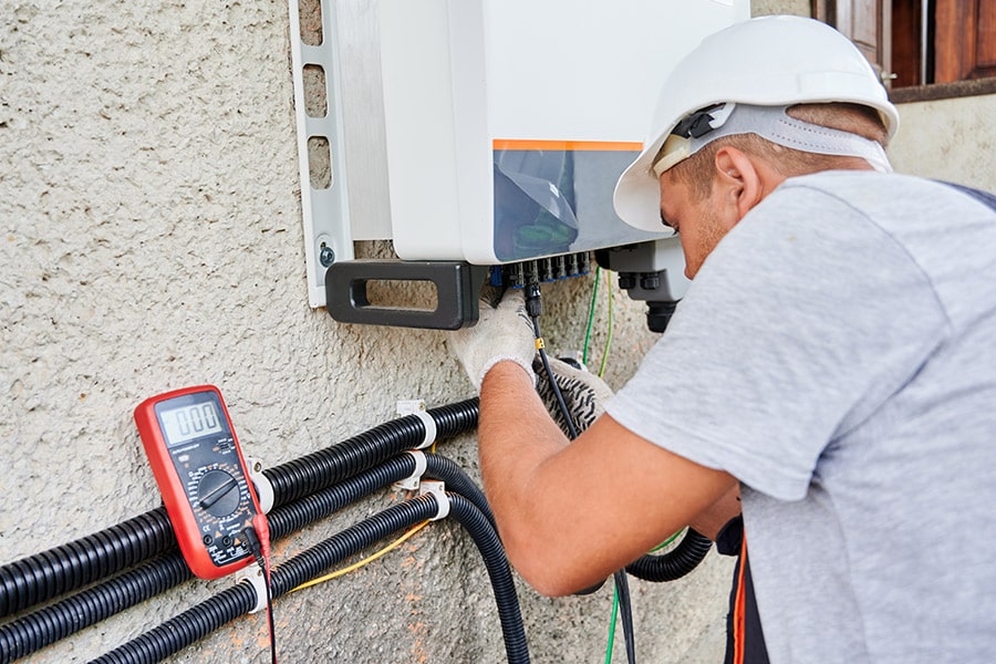 Professional working with energy storage and power sources.