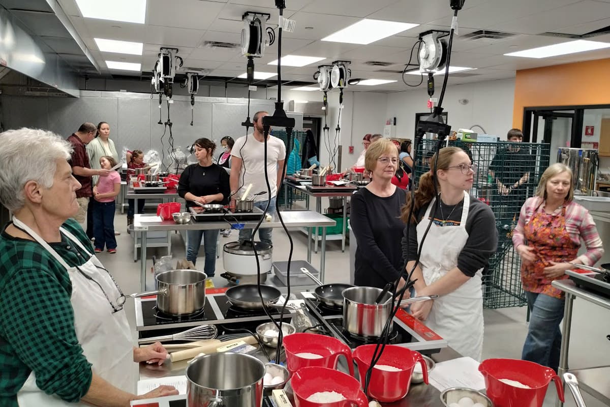 Students in the San Juan College Harvest Food Hub Kitchen utilizing the kitchen equipment