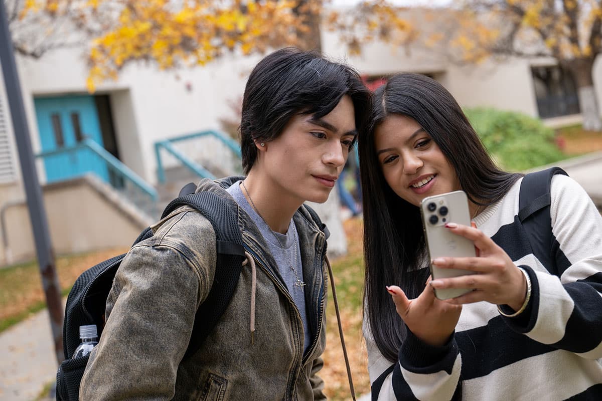 SJC Students in the Courtyard on Main Campus looking at their phone