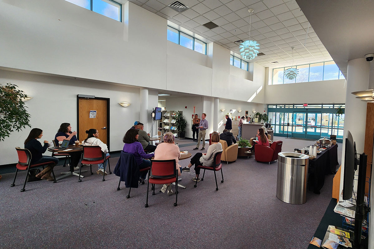 A group of business owners gathering in the foyer of the Enterprise Center on the San Juan College main campus